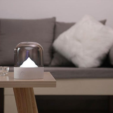 Sänglampa med upplyst berg under kupol