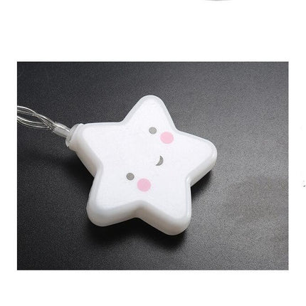 Vit ljusslinga med leende stjärnor